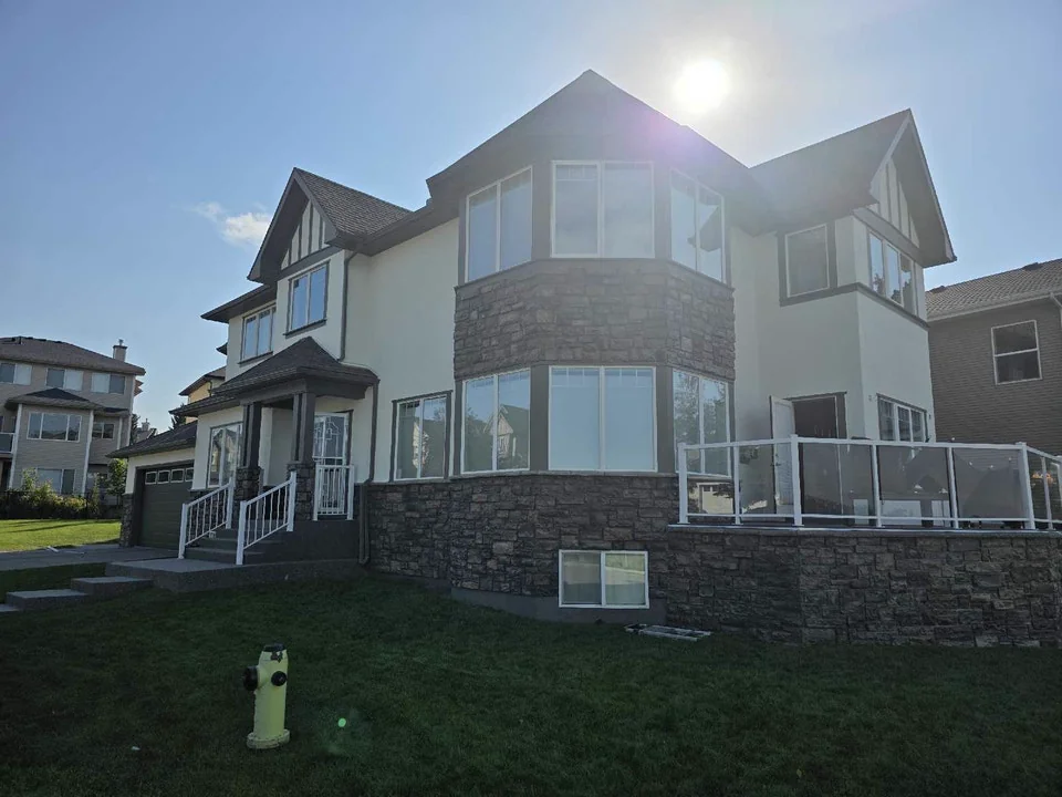 Sunlit stone-and-stucco home in Calgary repainted by Life Saver Painting