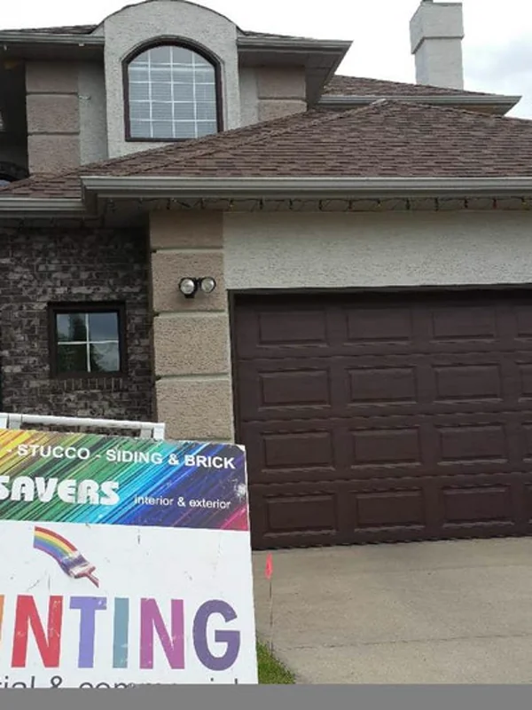 Life Saver Painting on site at a Calgary home — stucco, siding and brick